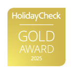 HolidayCheck Gold Award 2025 Logo in goldener Farbe